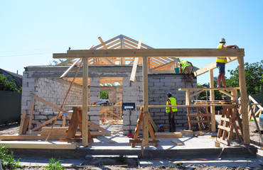 Roofers Building Wood Trusses Roof Frame House Construction. Roofing construction with wooden beams...
