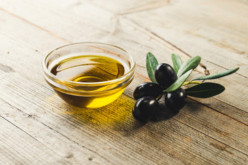 Olive oil with leaves and olives