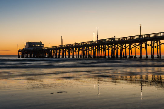 Newport beach pier orange glow sunset, California
