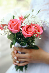 Bouquet with flowers in the hands of the bride