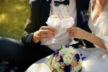husband and wife drink champagne from wedding glasses © dyageleva