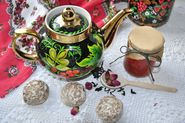 bright colors kettle on a white background, located next to the stick and wooden spoon with tea...