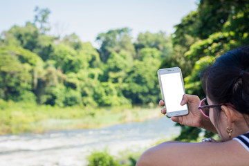 Beautiful woman play smartphone in garden,selective focus.
