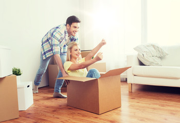Fototapeta na wymiar happy couple having fun with boxes at new home