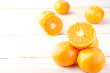 Fresh oranges cut on wooden background