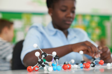 Female Pupil Using Molecular Model Kit In Science Lesson