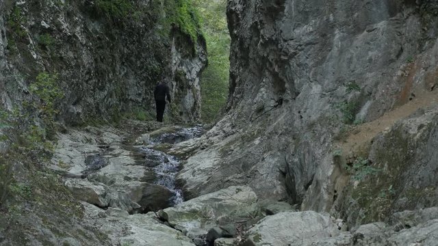 Beauty of nature in Eastern Serbia footage - Hiker passing through natural stone bridge