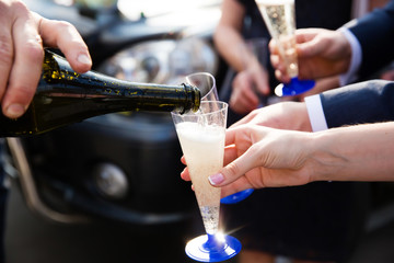 Pouring champagne into a glass on the wedding celebration