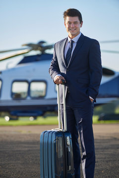 Portrait Of Businessman Standing In Front Of Helicopter