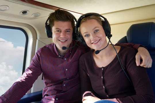 Couple On Vacation Taking Ride In Helicopter