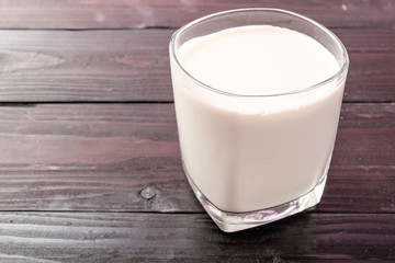 Fresh milk on wooden background