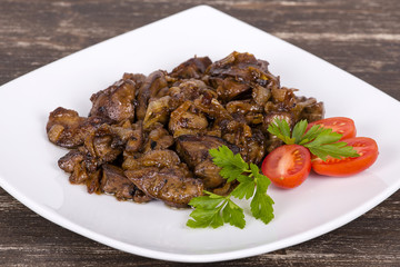 Chicken livers in a creamy sauce with onion on white plate