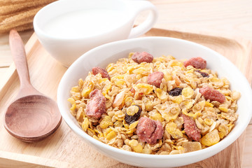 cornflakes and dry fruits on wooden background