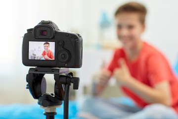 camera recording video of blogger boy at home