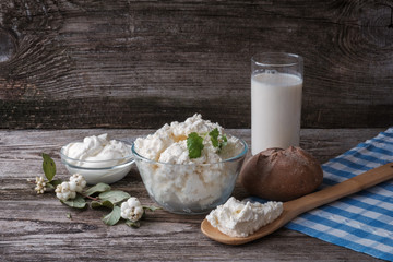 cheese, sour cream, milk in a glass container on the Board