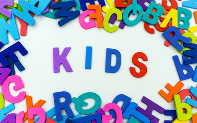 The letters made of plywood the words kids are on a white background