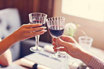 Couple eating romantic Dinner in a gourmet restaurant drinking wine and holding hands