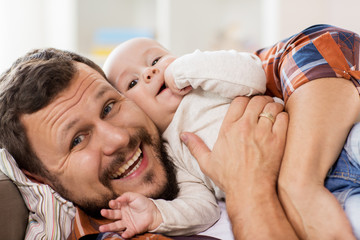 close up of happy father with little baby at home