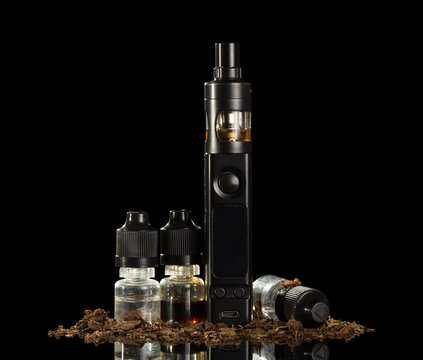Electronic cigarette, set of liquids for inhaling steam, close-up of tobacco, isolated on black