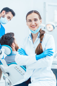 Portrait of a confident female dentist looking at camera in the dental office of a modern clinic