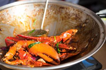 Prepared crab claws in chilli sauce at street food festival