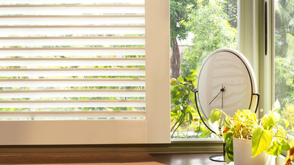 White window with morning sunrise and garden view.