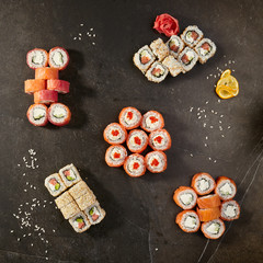 Set of sushi rolls on black background