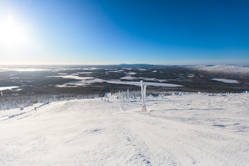 Beautiful cold mountain view of ski resort, sunny winter day with slope, piste and ski lift