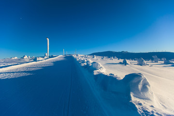 Beautiful cold mountain view of ski resort, sunny winter day with slope, piste and ski lift