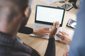 Close up on the hand of business people typing on the keyboard of a modern notebook  - technology,...