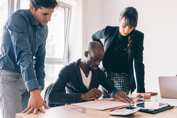 Multiracial business people working together connected with technological devices like tablet and notebook - teamwork, business, working concept