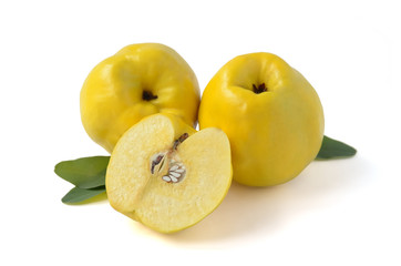 Two quince fruits with a half. Lengthwise cut