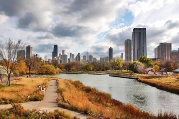 Foto op Aluminium Urban cityscape and modern architecture background.Chicago downtown skyline from Lincoln Park Neighborhood located at the Lincoln Park Zoo. Autumn cityscape with cloudy sky over skyscrapers.  © Maryna