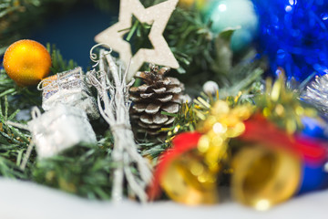 Branches of a Christmas tree with beautiful decorations on a blurred background.