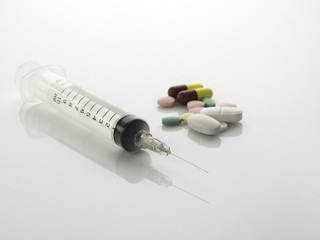 many medicine and syringe on white background