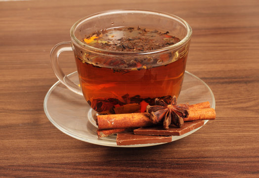 Tea Cup on a saucer, chocolate, cinnamon,sea buckthorn , on a white background