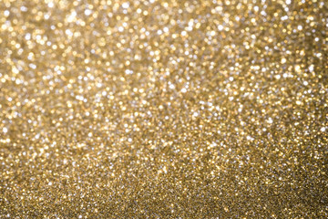 Gold Abstract Christmas twinkled bright background with bokeh defocused lights . Lights Festive background concept.