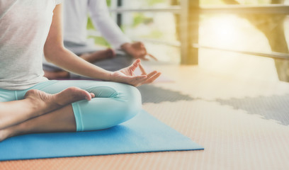 Young people are meditating on colorful tires for good health.