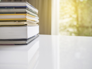 stack of books on white table 
