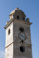 Fototapeta na wymiar Capo Corso, Corsica, 28/08/2017: il campanile bianco di Canari, un ex faro costruito per segnalare la costa ai marinai nel paese noto come il villaggio dei cento capitani