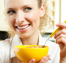 Cheerful woman eating cereal muslin