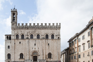 Fototapeta na wymiar Gubbio, Perugia, Italy - The facade of Palazzo dei Consoli. The palace is located in Piazza Grande, in Gubbio, and is one of the most impressive public buildings in Italy.