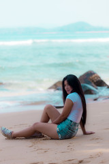 Fototapeta na wymiar portrait sexy asian woman posing on the beach for relax