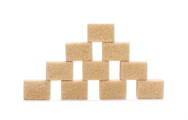 Brown cane sugar cubes isolated on white background