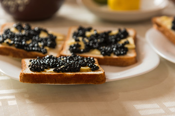 Sandvich with black caviar and butter