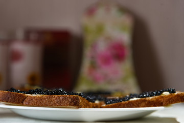 Sandvich with black caviar and butter