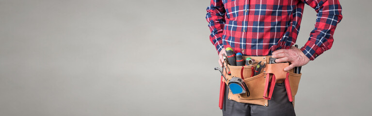 Building worker with tool belt