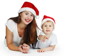 happy mother and baby in red Christmas hats. Isolated on white background