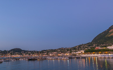 Fototapeta na wymiar Panoramic view of Forio at sunset, Soccorso Church, Ischia, Phlegrean Islands, Tyrrhenian Sea, Italy, South Europe