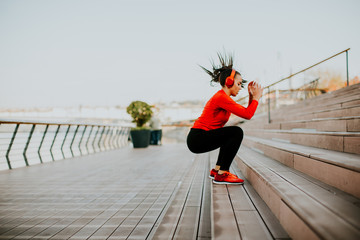 Young woman exercising jumping outside